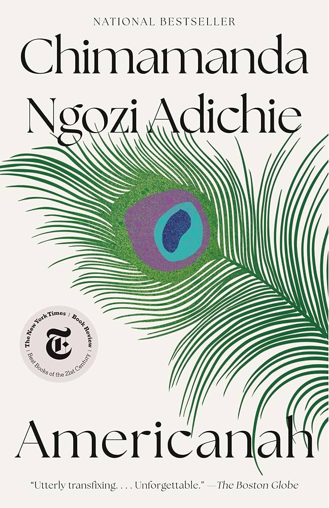 Americanah book cover by Chimamanda Ngozi Adichie. Features a large green and purple peacock feather, best-seller text.